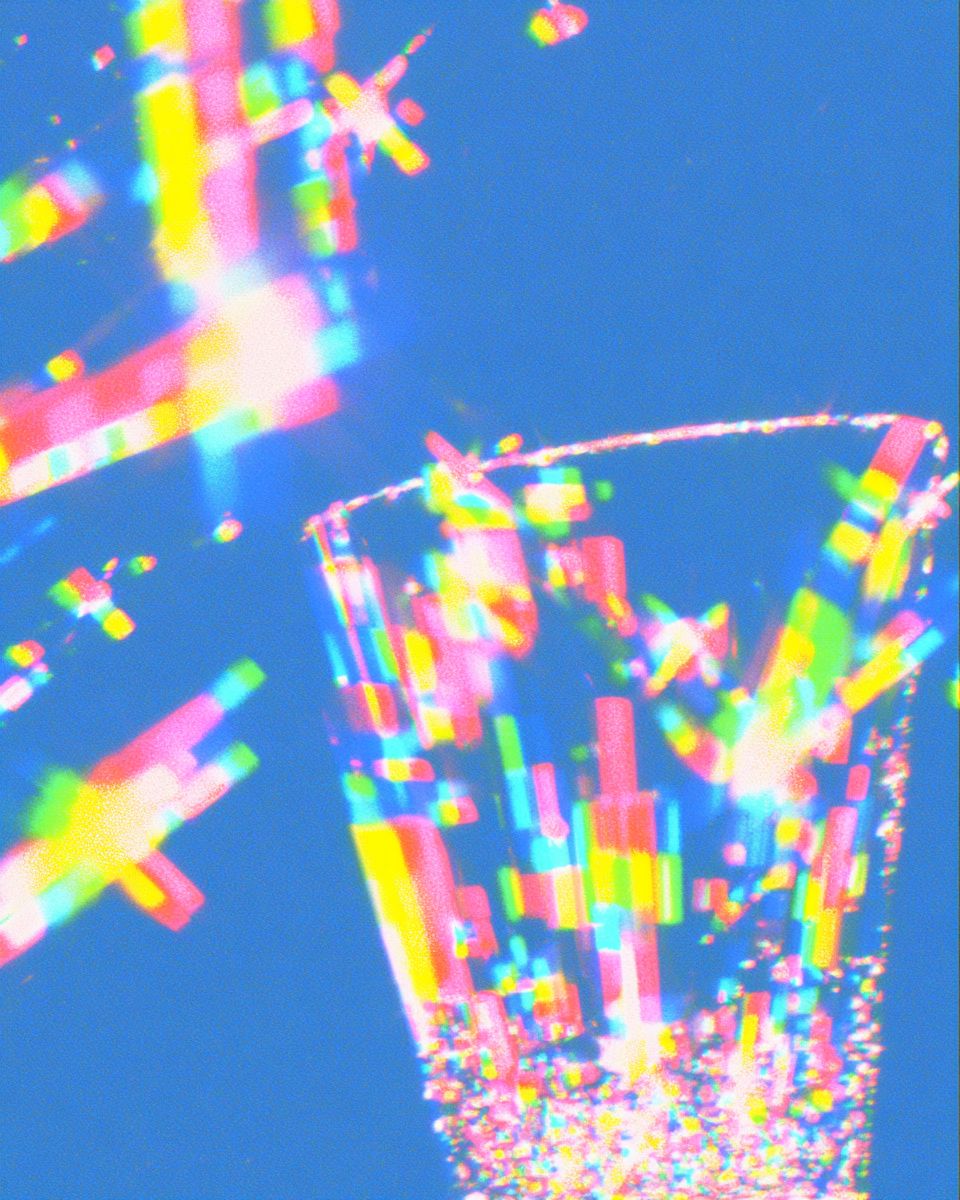 Light refracting through a glass into bands of colour