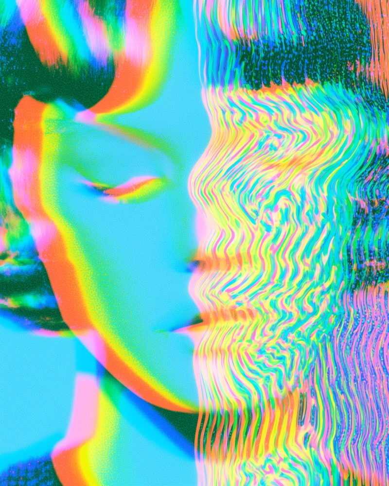 A face at rest, eyes closed, dissolving into rippling colour
